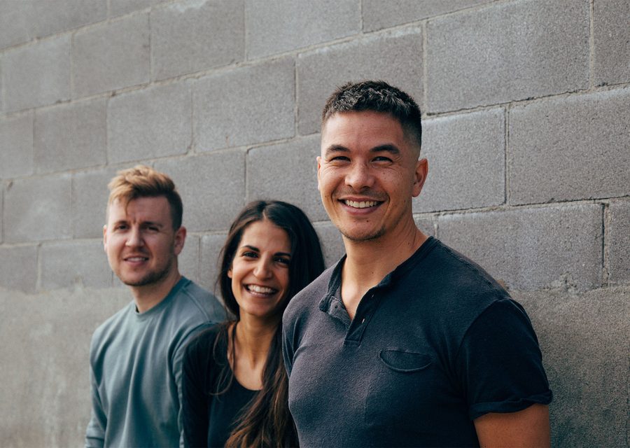 Three colleagues standing together outside the office
